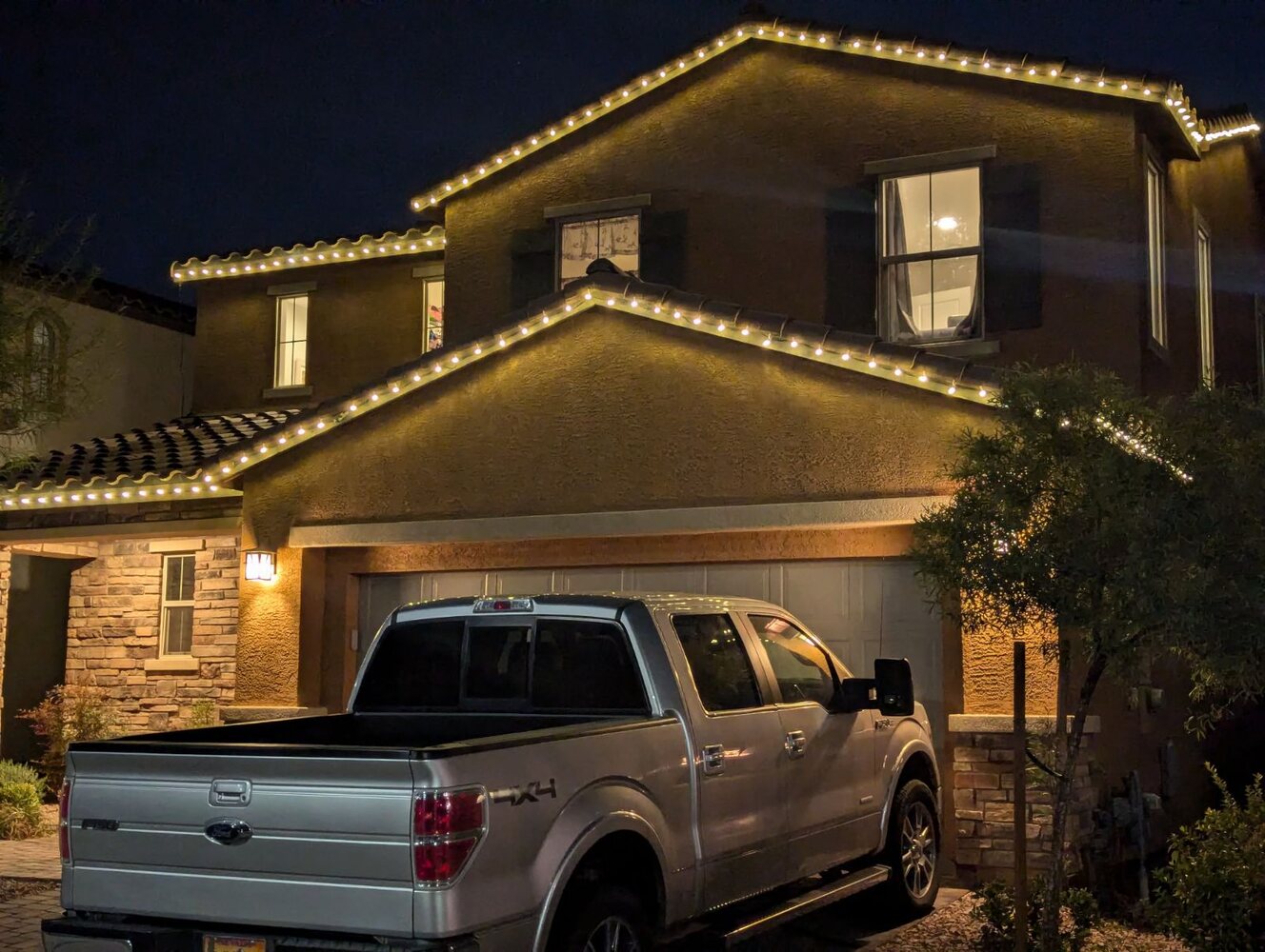 Warm white holiday lighting installed on a Las Vegas home